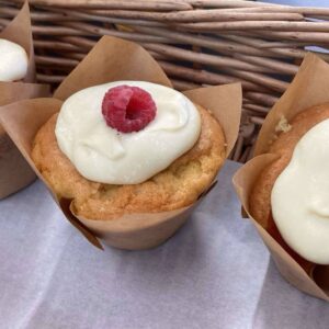 photograph of raspberry and white chocolate muffin with tulip case.